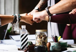 negative-space-office-team-building-fist-bump-desk-rawpixel